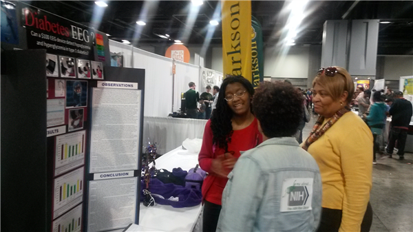 Photo 2-Carlea presenting her research to Dr. Carla Easter of NIH.jpg